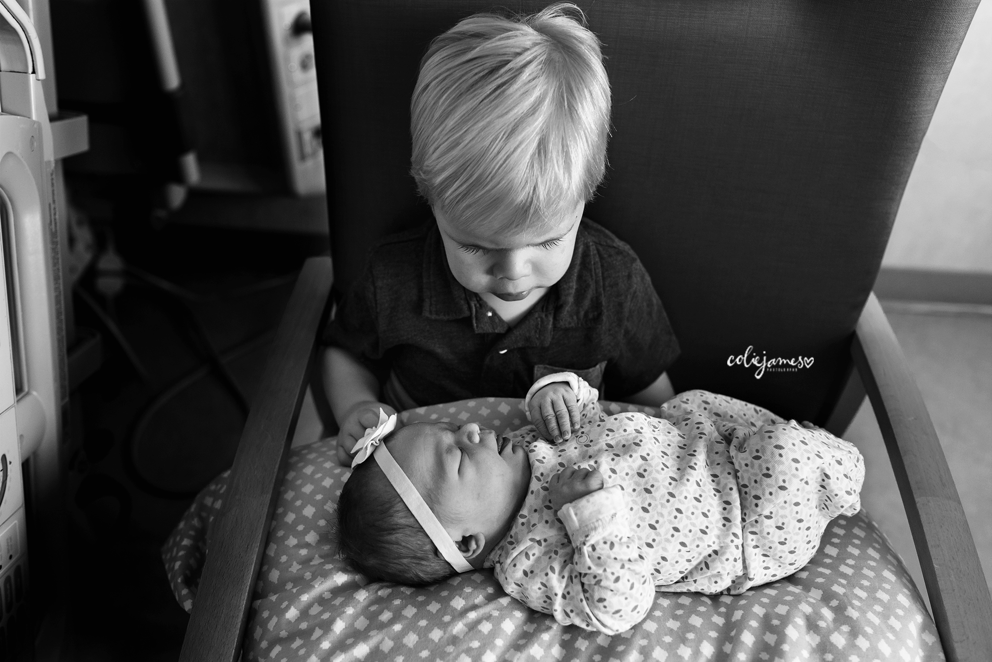 Denver Newborn Photographer holding baby sister