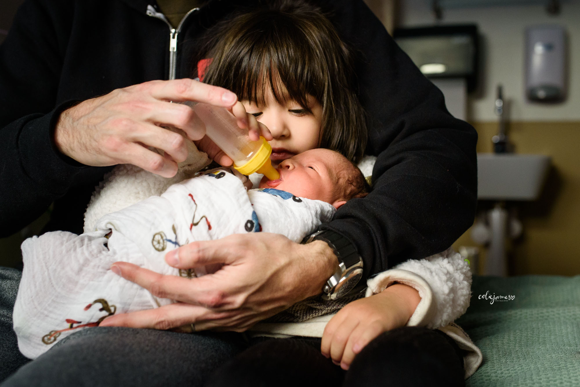 Littleton Newborn Photographer photographs big sister feeding baby